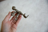 Textured vintage African aluminum archer in motion, with rich handmade patina.