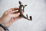Fluid form and handmade character of the vintage bronze man held for scale.