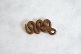 Vintage African iron snake showing its handmade details and rustic, aged surface.