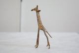 Vintage African bronze giraffe head showing light patina and mottled surface.
