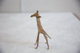 Side profile of the vintage African bronze giraffe, highlighting its textured surface and light patina.