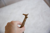 Vintage African bronze giraffe sculpture head with rich light patina held by hand.