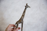 Visible texture and golden streaks on the vintage African bronze giraffe's body.