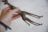 Vintage African dark bronze giraffe held, with golden streaked texture.