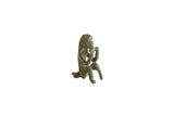 Vintage African bronze peg leg monkey sculpture with an oxidized patina, sitting to eat.