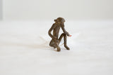 Slender profile of the vintage African bronze monkey in its seated pose.