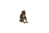 Vintage handmade African bronze monkey sculpture, sitting holding a banana, dark patina, 2 inches tall.