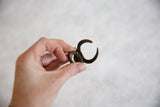 Vintage African bronze horned mask ring, showcasing its unique form and rich patina.
