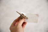 Elongated profile of a vintage African bronze lizard ring highlighting its cast texture.