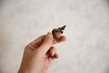 Vintage African bronze lizard ring held to show its handmade texture and scale.