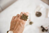 Vintage African bronze shield ring worn on a hand, demonstrating its statement size.