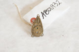 Vintage teardrop-shaped African bronze shield casting, with its handwritten inventory tag.