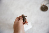 Side view showcasing the textured form of the cast bronze bird ring.