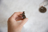 Detailed side view of the cast bronze bird perched on the textured ring band.