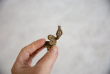 Angled view highlighting the textured casting of the vintage African bronze snake ring.