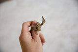 Vintage bronze snake ring worn on a finger, showcasing its sculptural form and textured band.