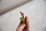 The textured profile and coiled body of a vintage cast bronze snake ring.