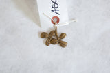 Vintage African bronze pendant showing its handmade clover form and aged patina.
