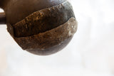 Textured detail of the rustic, aged repair on the antique wooden pitcher.