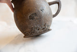 Aged wooden pitcher base showing its storied texture and imperfections.