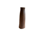 Tall antique African wooden vase with a slender handmade form and dark, weathered patina.