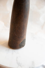 A characterful chip and aged texture at the base of the antique wooden vase.