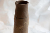 Aged wood texture and dark carved line on the mid-section of the African wooden vase.