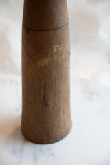 Natural wood grain and aged brown patina on the antique African vase.