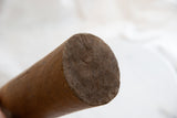 Close-up of antique African wooden vase, highlighting end grain and natural cracks.
