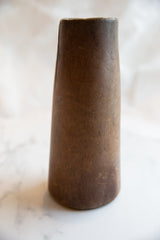 Antique African wooden vase with rich grain texture and aged patina.