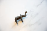 Vintage African bronze elephant's curled trunk with an aged, textured patina.