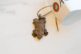 Vintage African copper turtle pendant with a detailed segmented shell and rustic patina.