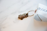 Vintage copper turtle pendant attached with a natural twine string to a paper tag.