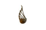 Vintage African bronze musical instrument with a sculptural, handmade form and dark aged patina.