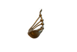 Vintage handmade African bronze musical instrument with a sculptural form and warm patina.