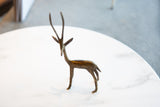 Handmade African bronze gazelle sculpture showcasing its dark patina and turning head.