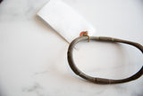 Antique African bronze artifact's unique segmented texture and rich, dark patina.