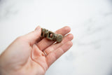 A close view of the antique silver bracelet's geometric form and oxidized patina.