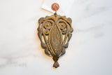 Vintage abstract owl medallion with a textured bronze surface and rich gold patina.