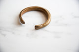 Angled view of the open ends of the antique bronze cuff bracelet.