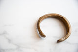 Antique African bronze snake cuff showing its open form and rich gold patina.