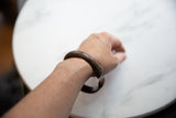 Antique bronze snake cuff bracelet worn on a wrist, demonstrating its scale and fit.