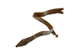 Antique African bronze arm cuff in a snake shape with a small rider figure and engraved patterns.