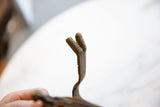 Finely ribbed texture on the forked bronze tip of the antique African cuff.