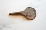 Rugged, mottled brown and orange patina on the vintage African iron utensil.