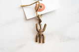 A close-up of the vintage bronze pendant's aged patina and rustic, handmade texture.