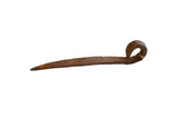 Vintage handmade African iron pick with a rustic, rusted patina and a curved handle.