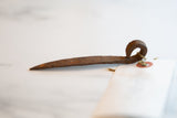 Side profile of the vintage iron pick highlighting its hand-forged shape and rust patina.