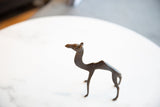 Vintage African dark bronze camel showing unique broken tail and handmade character.
