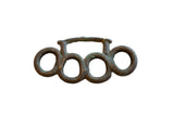 Vintage African bronze knuckles with four rings and a weathered, handmade texture.